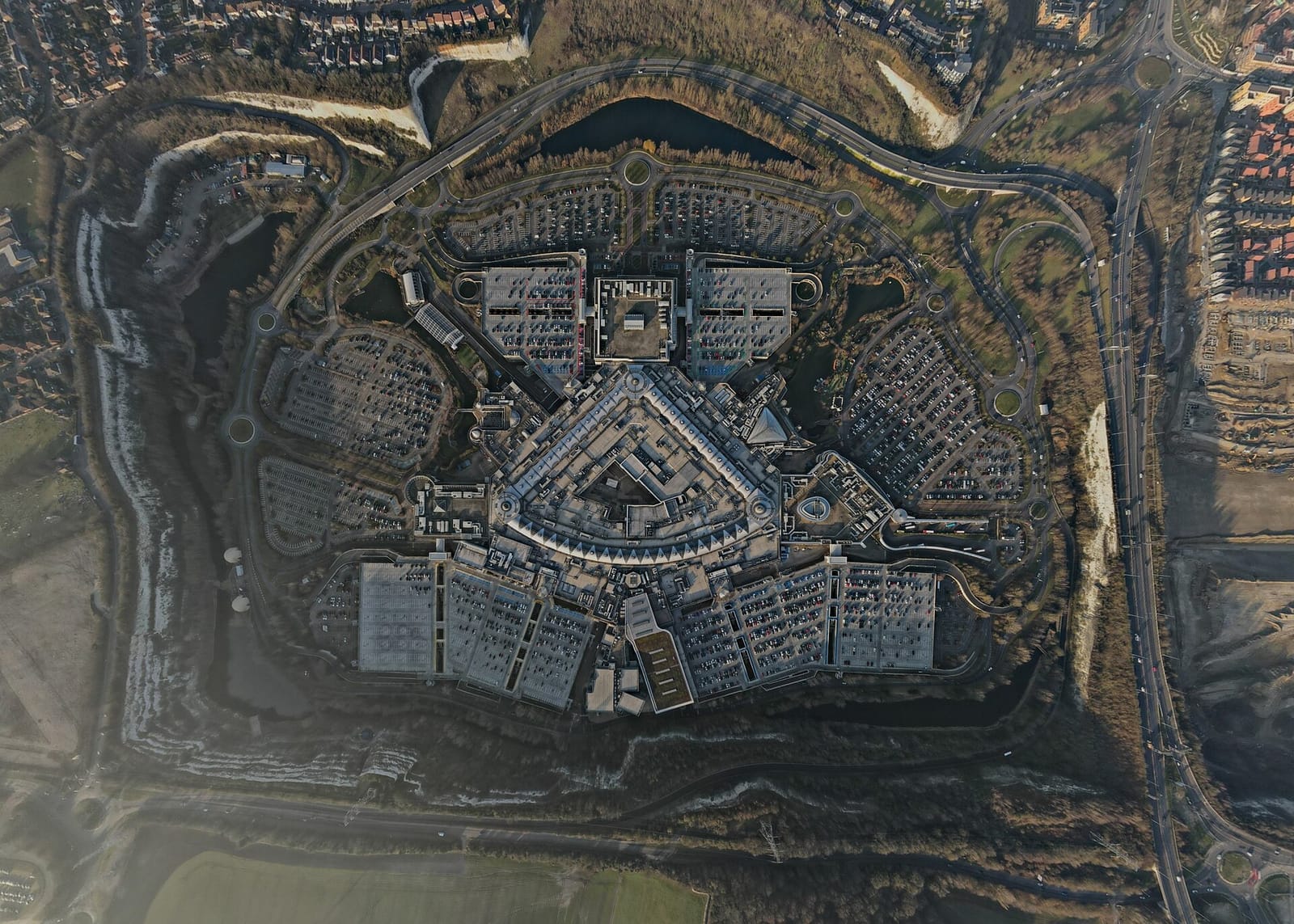 The Bluewater shopping centre from directly above, its three wings and car parks set inside the old chalk quarry at Greenhithe.