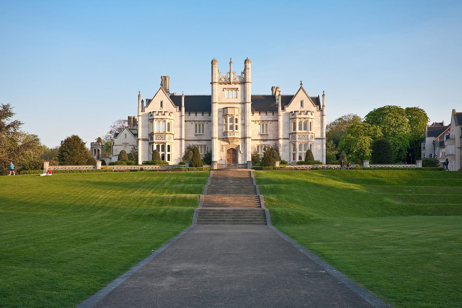 Ingress Abbey in Greenhithe, a nineteenth century mansion in pale stone above a wide lawn and a flight of steps.