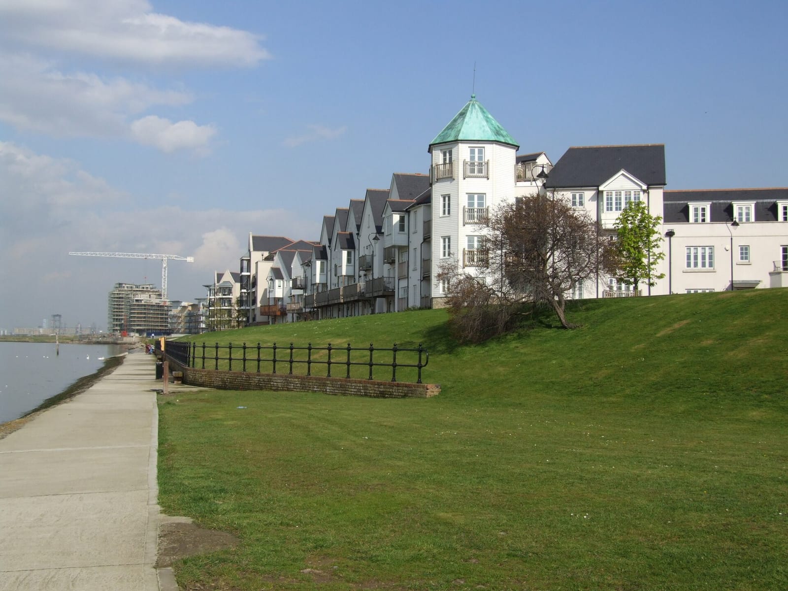 Riverside houses and flats at Ingress Park in Greenhithe, seen along the Thames path on a clear day.