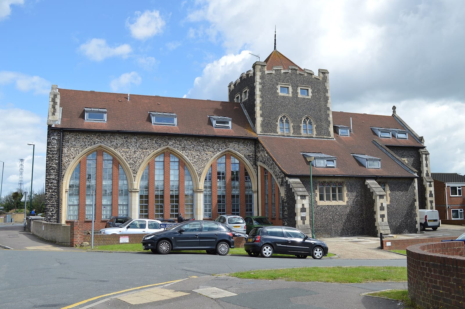 The former All Saints church in Swanscombe, a flint building with a battlemented tower, now converted.